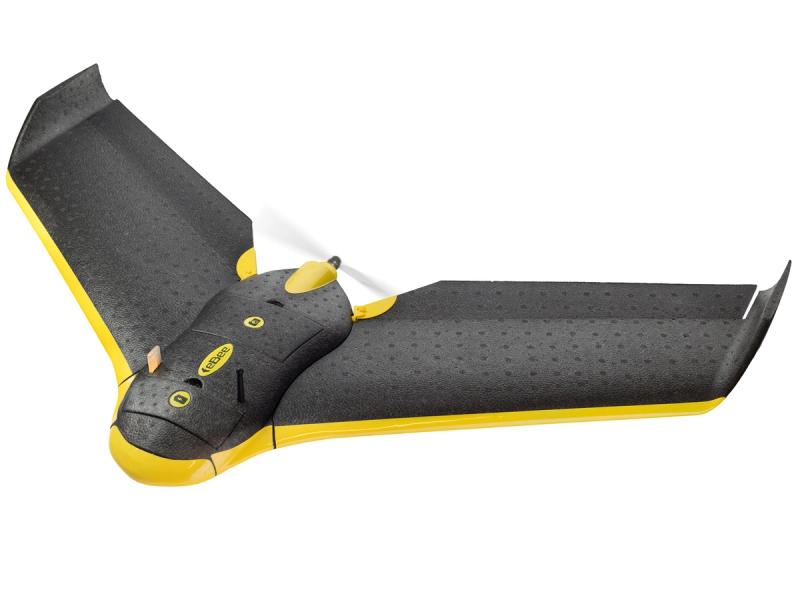 A black fixed wing drone with yellow accents and a small spinning propellor.