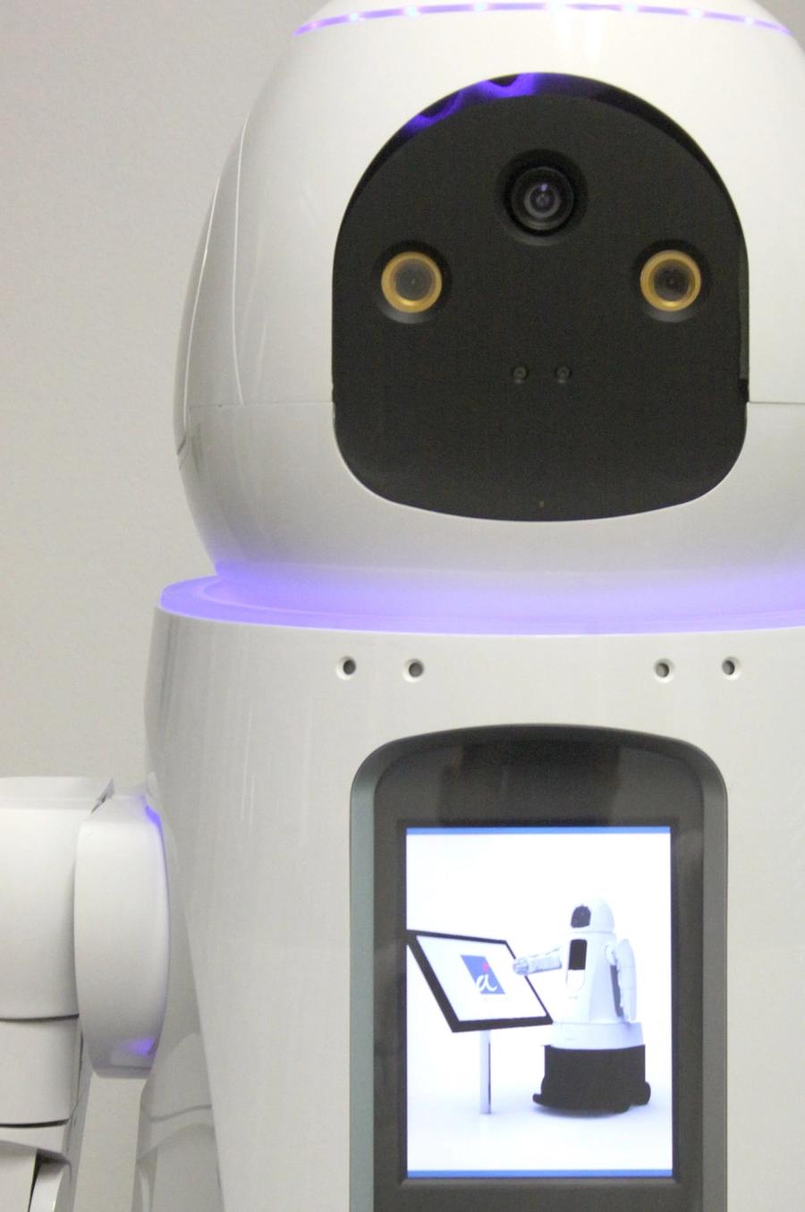 Close up of the robots face shows two eye cameras, and one on its forehead.