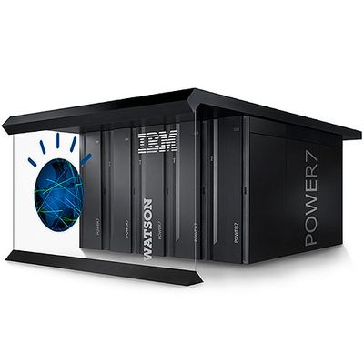 A room sided black container full of servers displays text on a glass wall at the front that reads "IBM Watson" and shows a logo with a blue circle and lines on top.