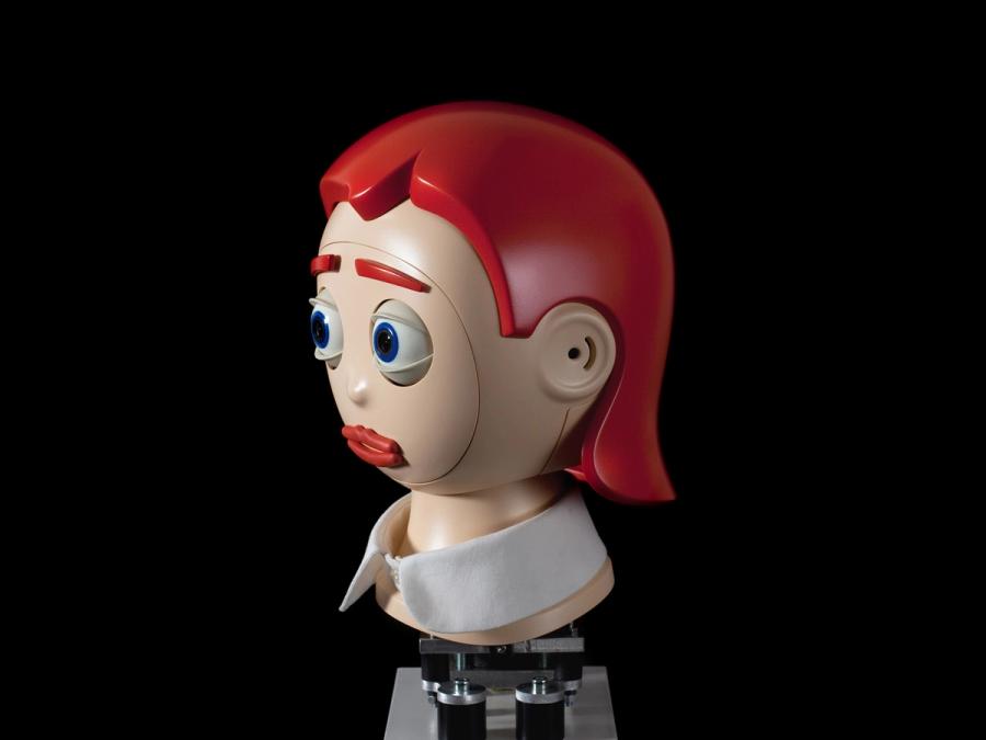 A side view of Flobi shows its removable faceplate. This version has red eyebrows and hair.