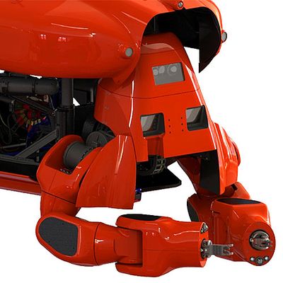 Close up of a red submarine like robot with gripper hands.