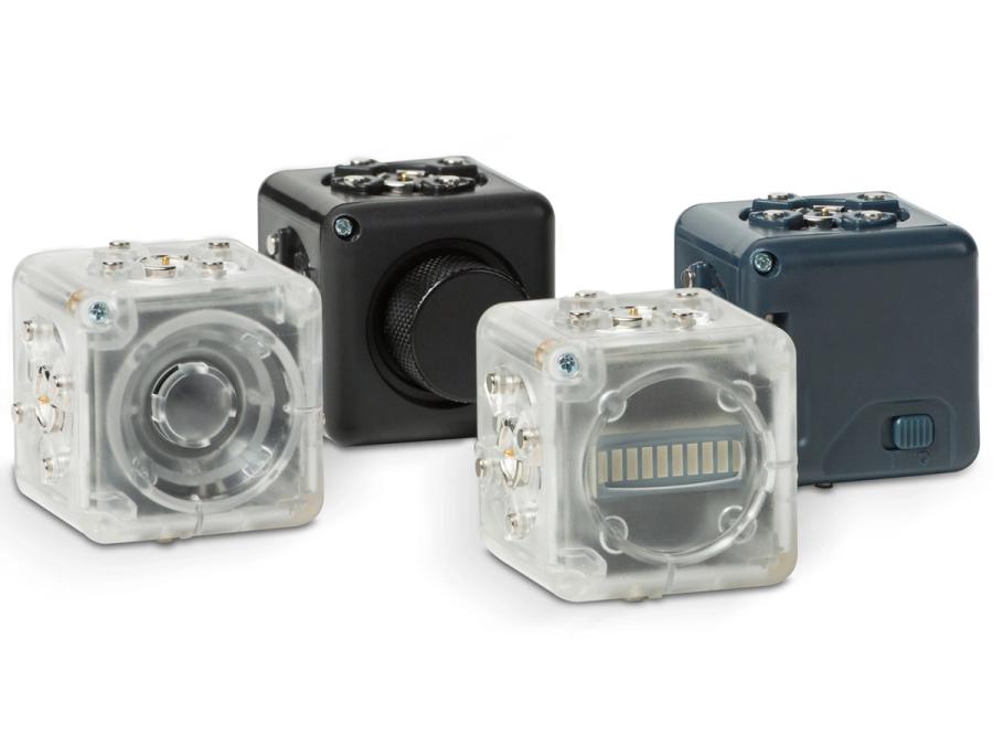 Four robotic cubes in hard casing with connecting pieces visible.