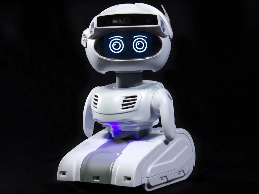 A small, friendly looking robot with a white base, vented torso, two small arms, and a rounded head with two expressive eyes and a strip of sensors on top.