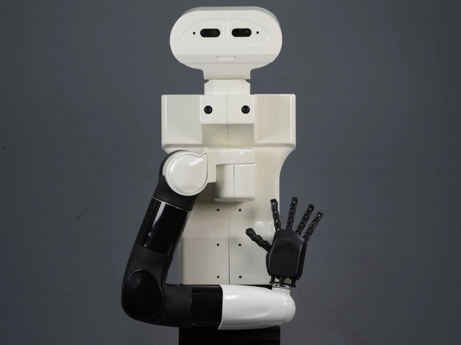 A simple white humanoid with a black arm and five digit hand opened in front of its torso.