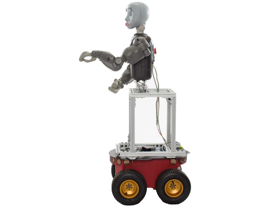Side view of a robot whose torso is attached to a basic frame base that sits on a wheeled red robot.