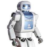 A white bipedal robot with a blue faceplate and torso, labelled MAHRU. 