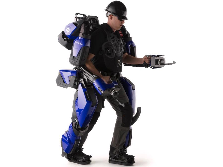 A person wearing a full body exoskeleton including two arms with hooks.