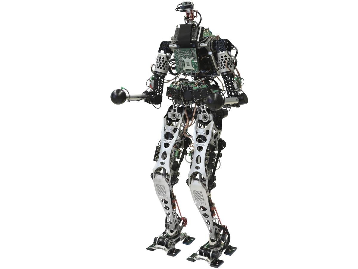 A humanoid bipedal robot with exposed electronics and a head consisting of two stacked rectangles with cameras and sensors.