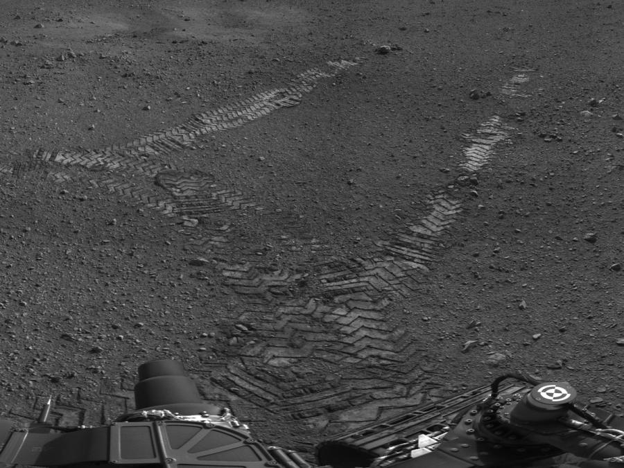 Black and white photograph of tracks on the surface of Mars.