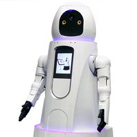 A white cylindrical robot which is wider at its base has a display screen on its torso, two hands with five black fingers each, and a simple black and white face. A ring of purple light at its neck and the bottom of it's torso are glowing.