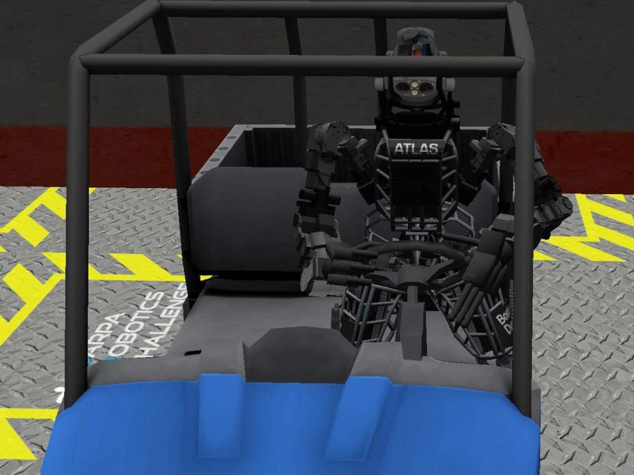 Image of a robot sitting in a cart with hands on a steering wheel.