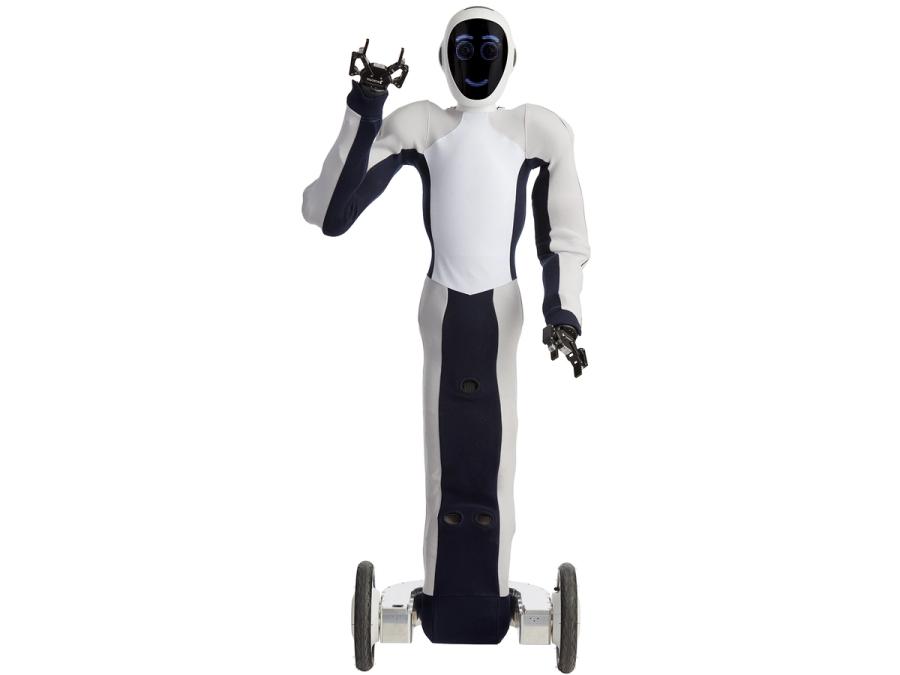 A black and white soft humanoid on a dual wheel platform, with a face displaying blue circles for eyes, and a smile. One of it's two gripper hands is raised in a greeting.