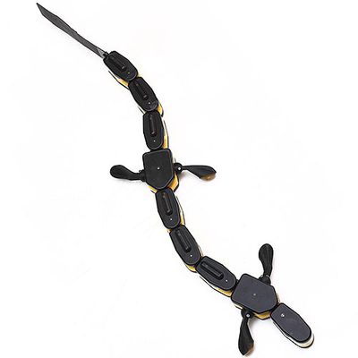 A black salamander shaped robot with four flipper feet and a segmented body with a tail.
