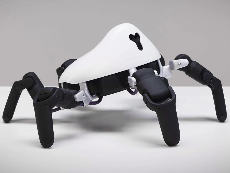 A robot with 6 black legs extending and bending out of a white abdomen.