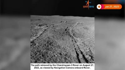 Tracks on the lunar surface left by the Pragyan rover, with a dark sky in the horizon.