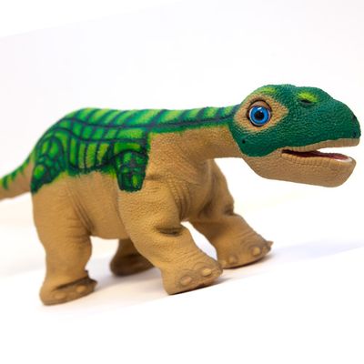 A friendly green and brown baby Camarasaurus dinosaur robot.