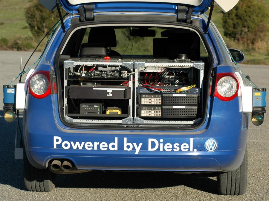 The blue car's trunk is open, and has two racks full of servers and electronics. It's rear says Powered by Diesel.