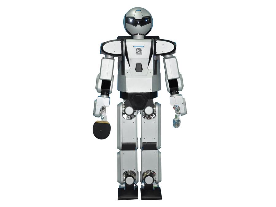 A silver humanoid robot holds a ping pong paddle.