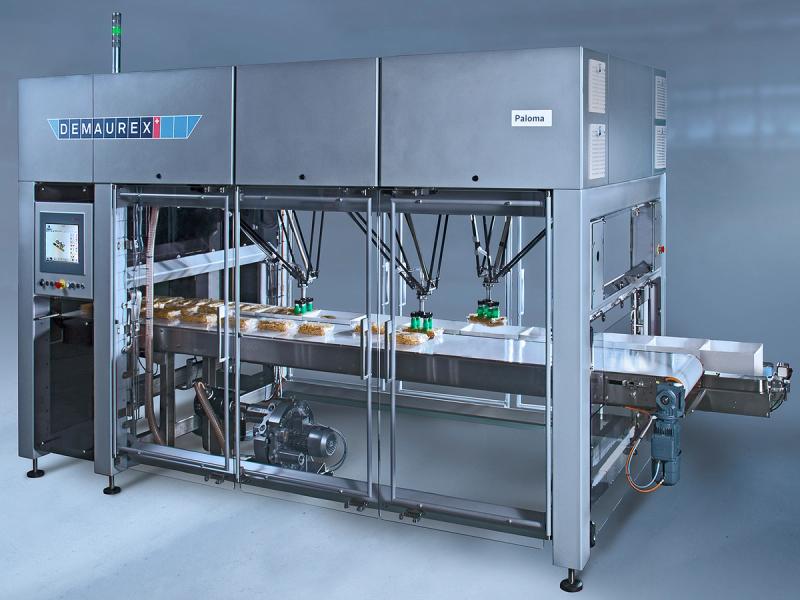 A large pick and place machine packages food.