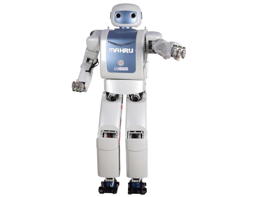 A standing white bipedal robot with a blue faceplate and torso, labelled MAHRU strikes a pose with one fist pointed at the camera.