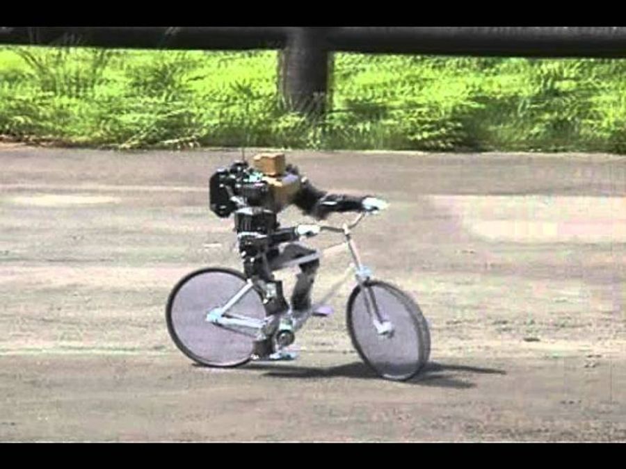 The little humanoid rides a bicycle.