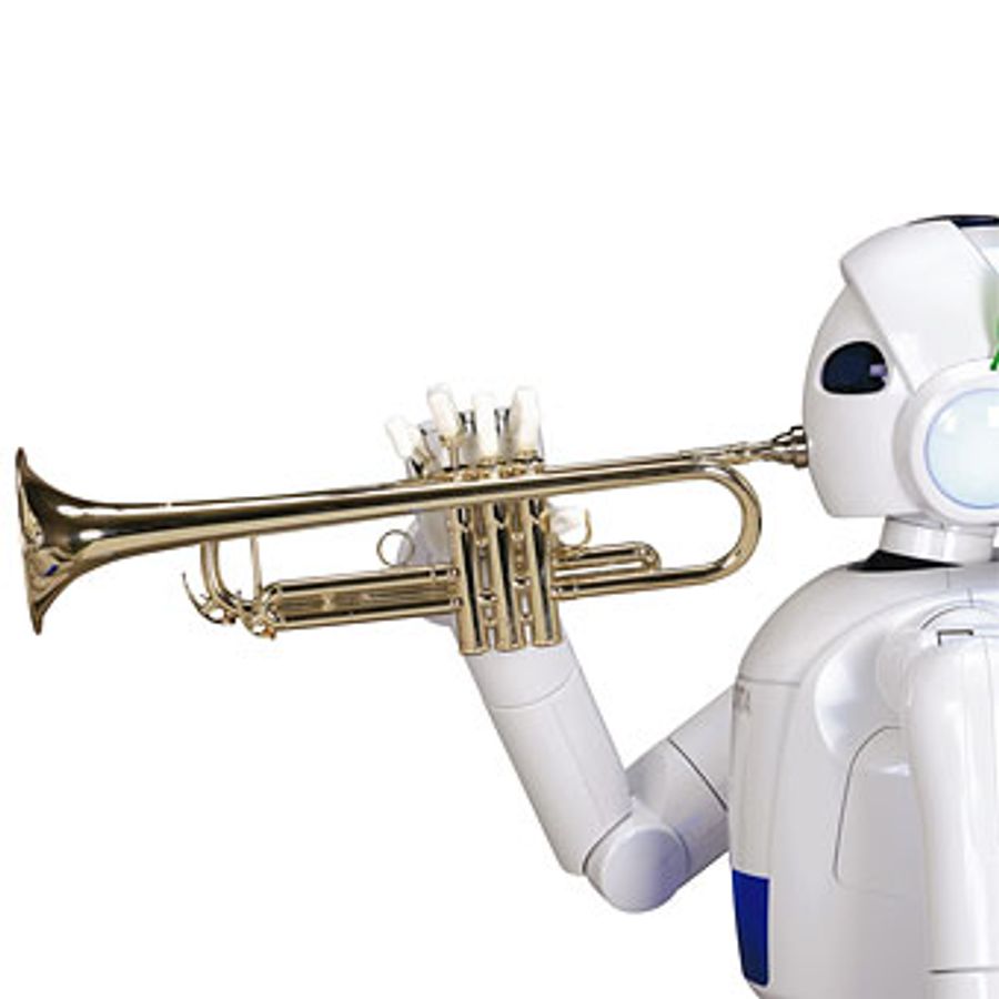 A white robot holds a trumpet to its mouth.
