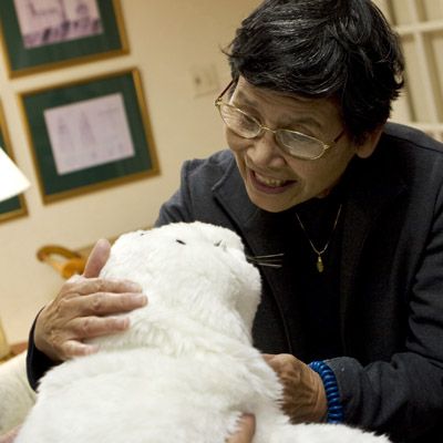 Takanori Shibata explains Paro's therapeutic benefits, which include reducing stress and stimulating social interactions.