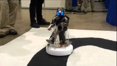 Darwin-OP rides a Roomba.