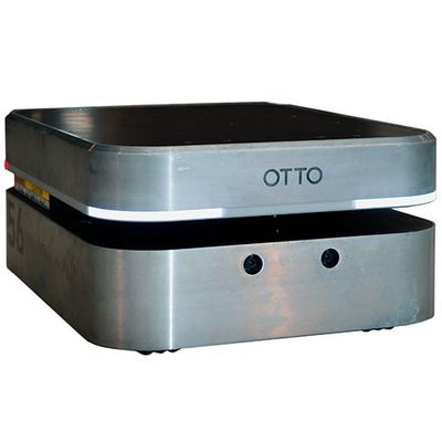 A squat, square, silver mobile robot with two layers and the name OTTO on it.