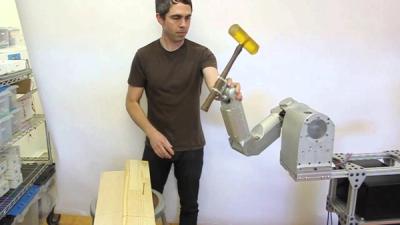 Teaching a robot how to use a hammer.
