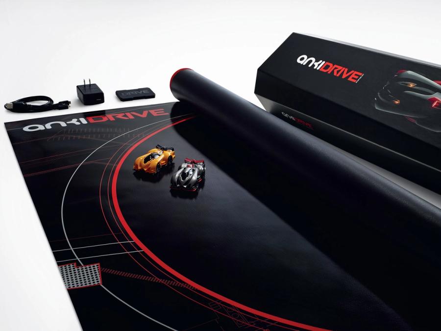 A race track mat with two small race cars on it.