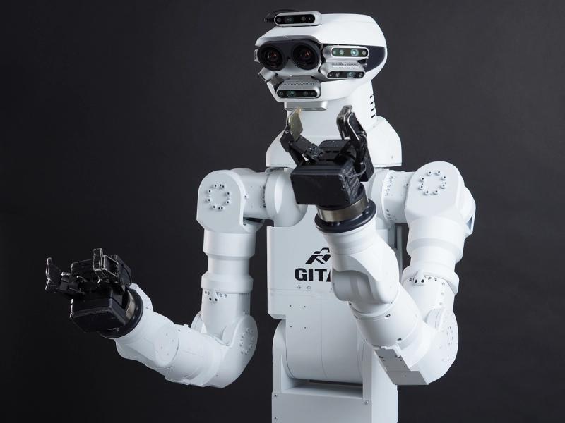 GITAI G1 has a shiny white humanoid torso with two industrial arms ending in black two finger grippers, and a head composed of many horizontal strips with sensors, as well as two larger eyes with cameras.