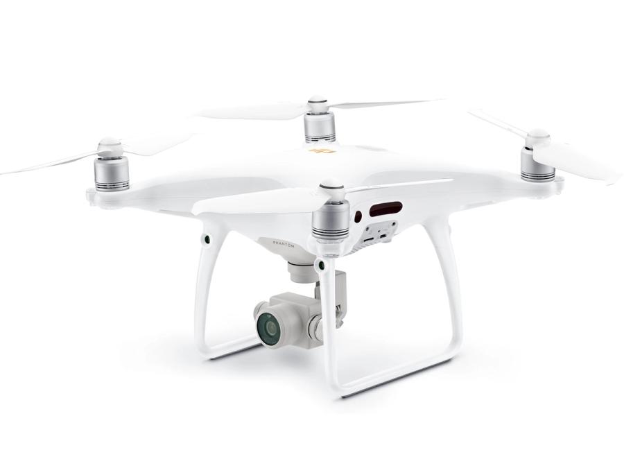 A small white drone with four propellers on top and a camera on its underside.