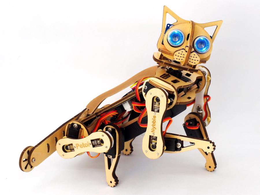 A wood colored robotic cat, with wires and assemblage visible. It has bright blue eyes and wood cut ears.