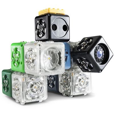 Eleven connecting robotic cubes form a small humanoid shape.