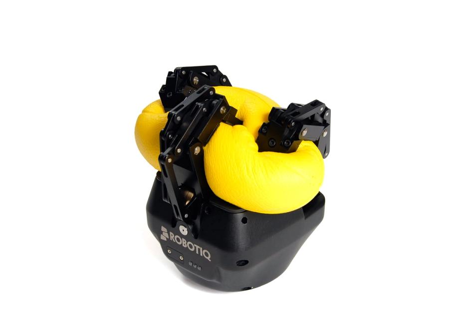 Three black robotic fingers smush a yellow ball.