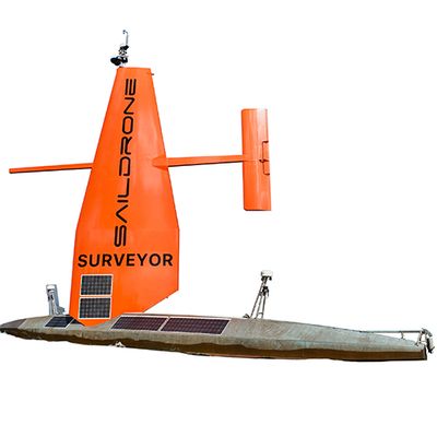 An uncrewed surface vehicle with horizontal silver unit with multiple solar panels and a large orange sail with solar panels rising vertically, and a rudder running parallel.