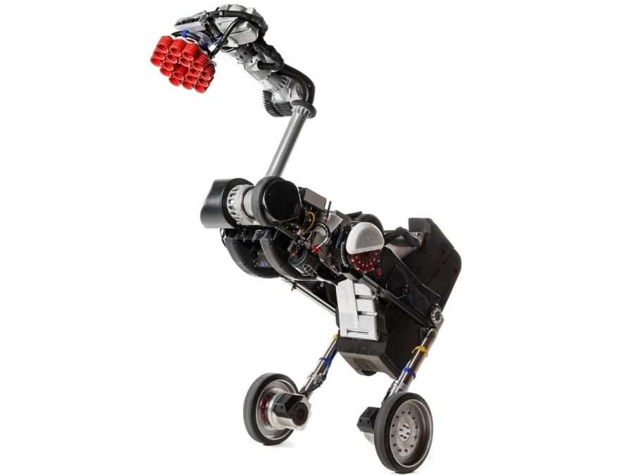 A two-wheeled balancing robot with a tall body including a jointed extendable arm with a pattern of red suction cups on the end.