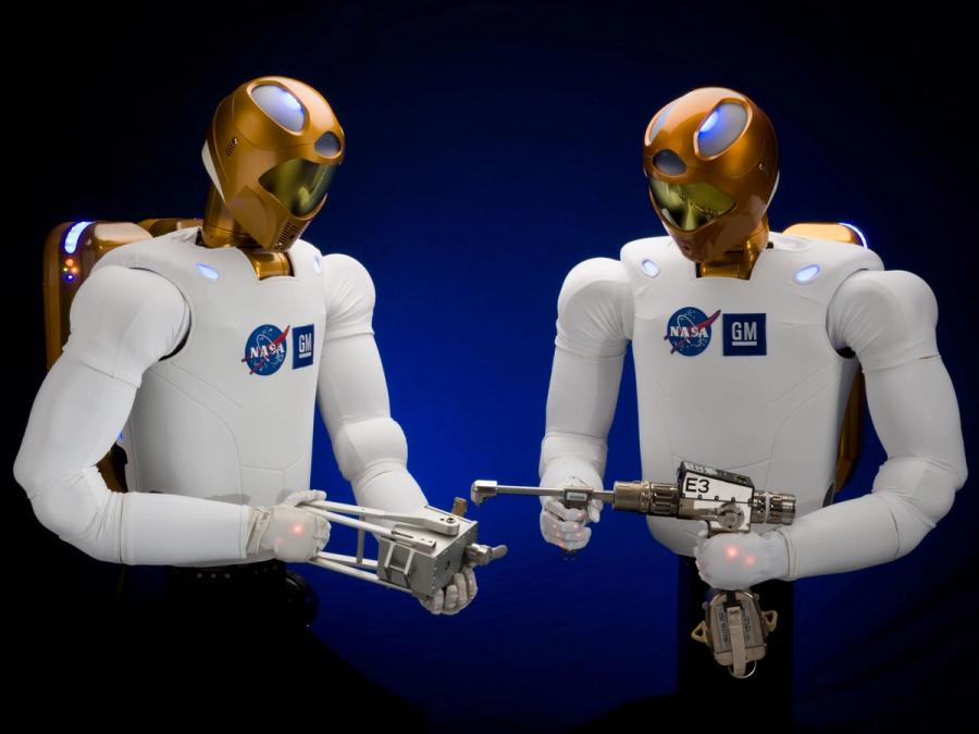 Two humanoid astronauts hold tools.