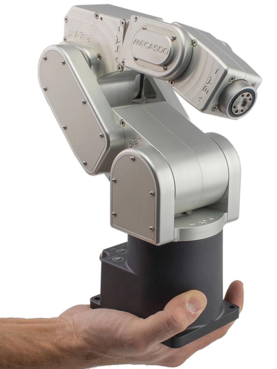 A hand holds the black base and silver robotic arm, which is bent.