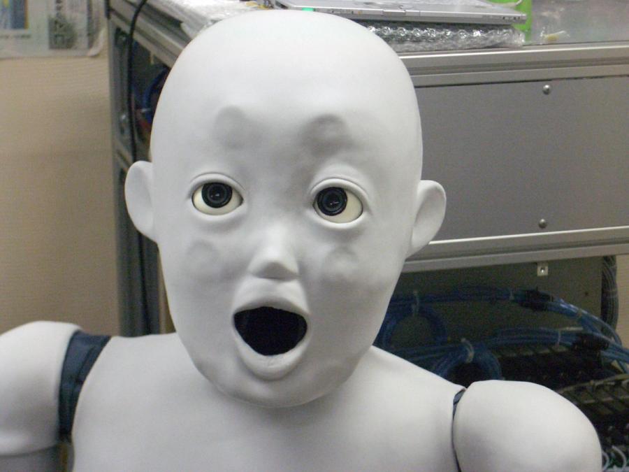 Close up of the robots face with a wide open mouth and expression of suprise.