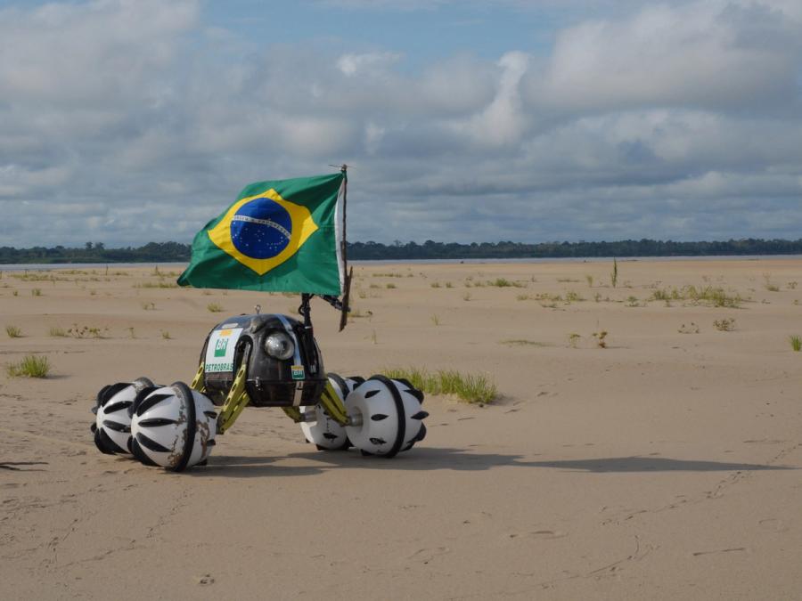 The robot carries a green, yellow and blue flag.