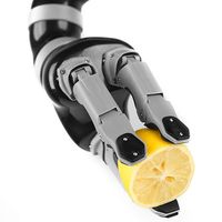 A three-fingered robotic arm squeezes a lemon.