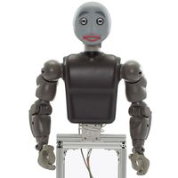 A robot with a torso, two arms with gripper hands, and a smiling face, attached to a frame base.
