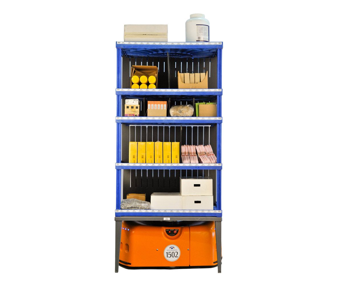 A series of images show a rotating squat orange unit which carries shelving full of items for sale.