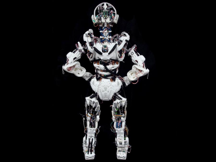 Rear view of a humanoid robot whose structure is exposed.