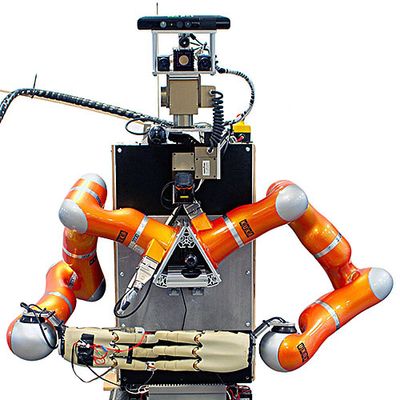 A vertical rectangular box supports two industrial orange arms and hands with four fingers. The robots head is composed of cameras and a sensor bar.