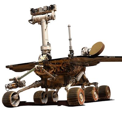 A silhouetted illustration shows Spirit, a large rover with six tracked wheels, solar panels, and a neck with cameras like a face.