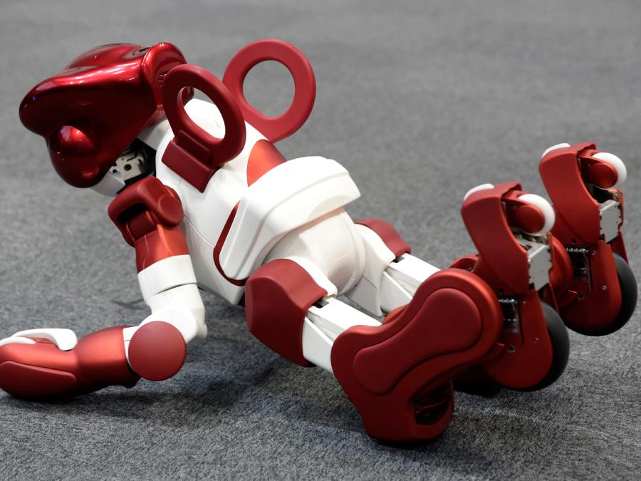 The robot lies prone on the ground, but has raised it's head, chest and legs to get up.