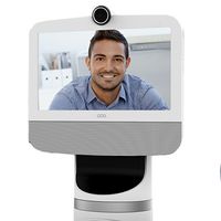 Close up of a telepresence screen with a smiling man on it.